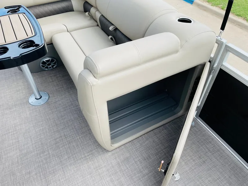 Slide: The Image of 2025 Sun Tracker SportFish 22 DLX interior with beige seating and storage compartment. - 20