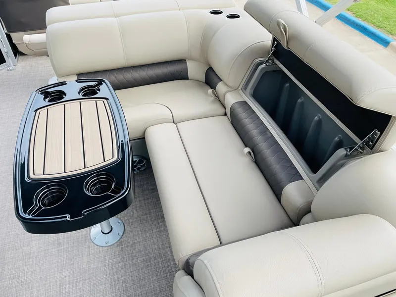 Slide: The Image of 2025 Sun Tracker SportFish 22 DLX interior with beige seating and a multifunctional table. - 27