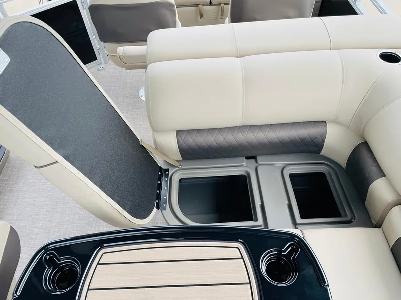Slide: The Image of 2025 Sun Tracker SportFish 22 DLX interior with storage compartments and cup holders. - 30