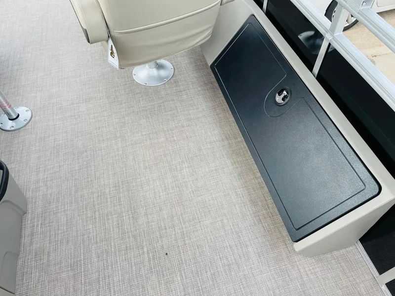 Slide: The Image of 2025 Sun Tracker SportFish 22 DLX interior with beige seating and storage compartment. - 31