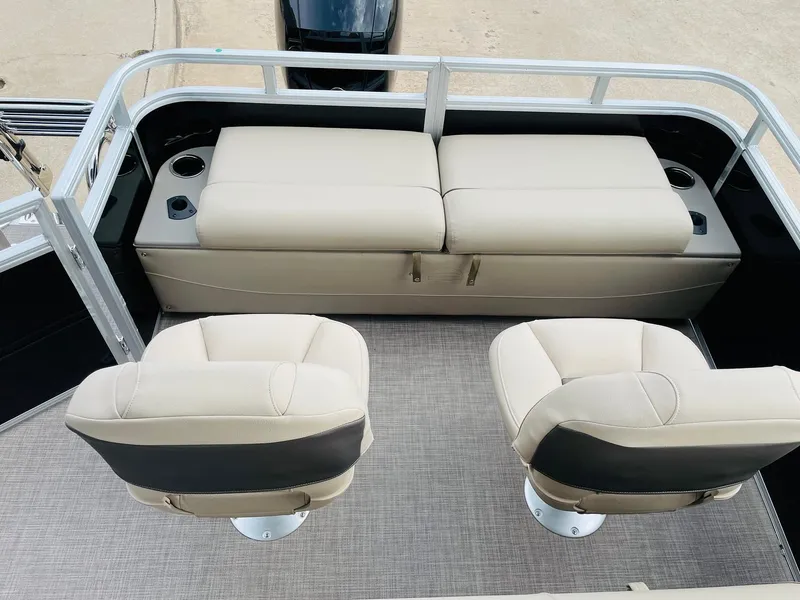 Slide: The Image of 2025 Sun Tracker SportFish 22 DLX boat interior with beige seating and cup holders. - 33
