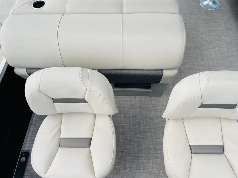 Slide: The Image of 2025 Sun Tracker SportFish 22 DLX boat interior with beige seating and carpeted flooring. - 34