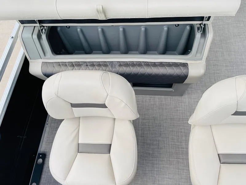 Slide: The Image of 2025 Sun Tracker SportFish 22 DLX boat interior with open storage and cushioned seats. - 35