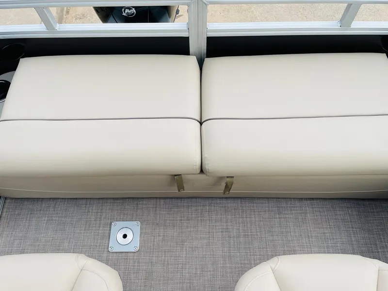 Slide: The Image of 2025 Sun Tracker SportFish 22 DLX boat interior with beige cushioned seating and carpeted floor. - 36