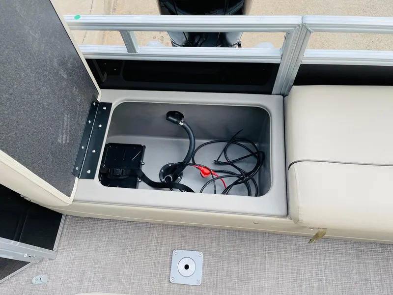 Slide: The Image of 2025 Sun Tracker SportFish 22 DLX storage compartment with wiring and connectors. - 38