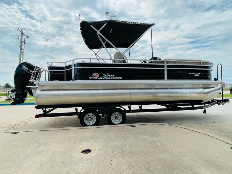 Slide: The Image of 2025 Sun Tracker SportFish 22 DLX pontoon boat on trailer, side view. - 4