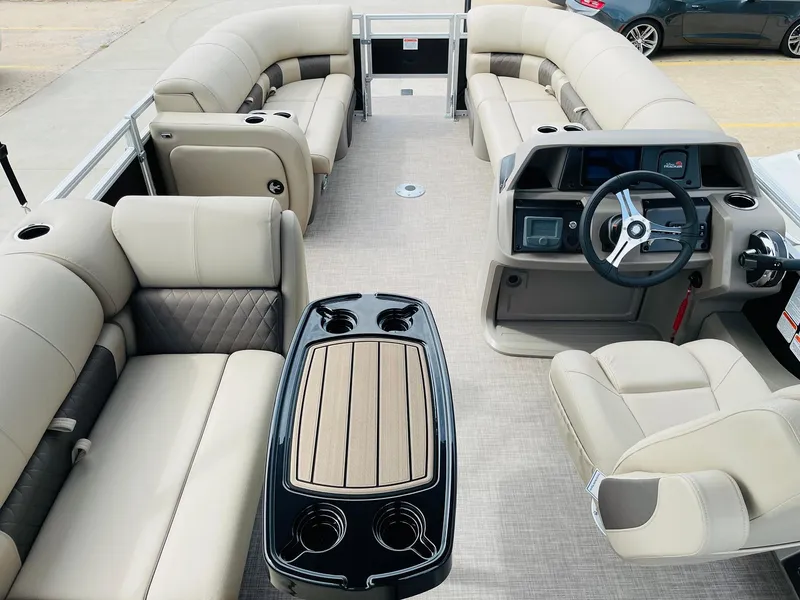 Slide: The Image of 2025 Sun Tracker SportFish 22 DLX pontoon boat interior with plush seating and modern helm. - 8