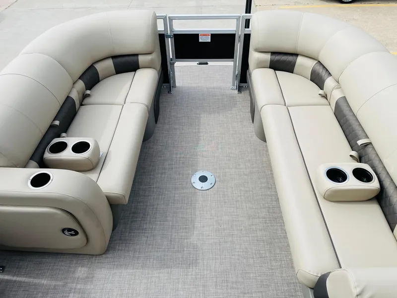 Slide: The Image of 2025 Sun Tracker SportFish 22 DLX interior with beige seating and cup holders. - 9