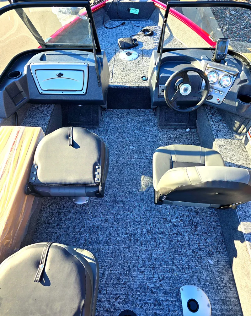 Slide: The Image of 2025 Tracker Pro Guide V-16 WT boat interior with seating and steering console. - 2