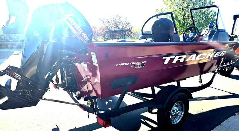 Slide: The Image of 2025 Tracker Pro Guide V-16 WT boat on trailer, side view in sunlight. - 4