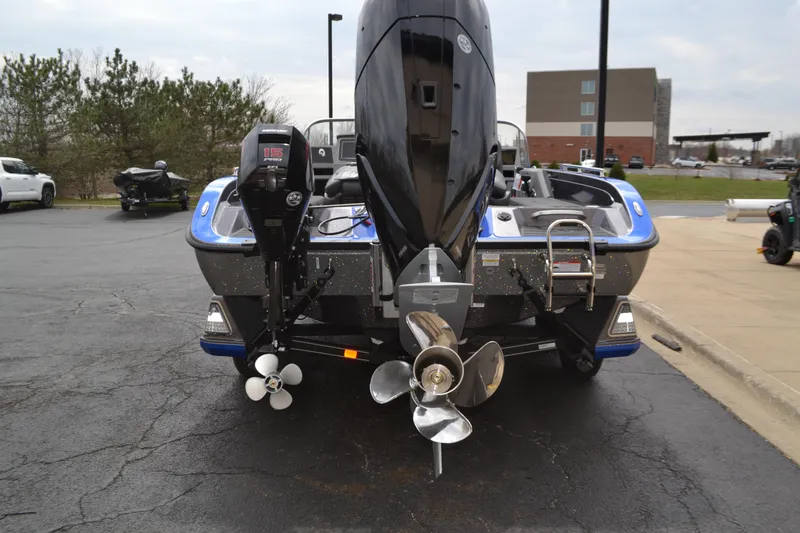 Slide: The Image of 2025 Ranger 621FS Pro boat, rear view with dual propellers, parked outdoors. - 2