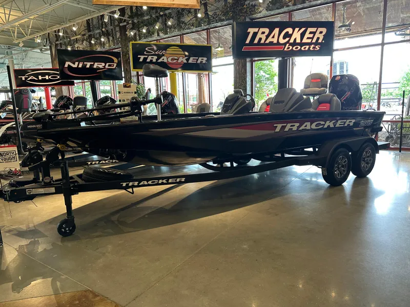 The Image of 2025 Tracker Savage 215 boat displayed in showroom with Tracker branding. - 0