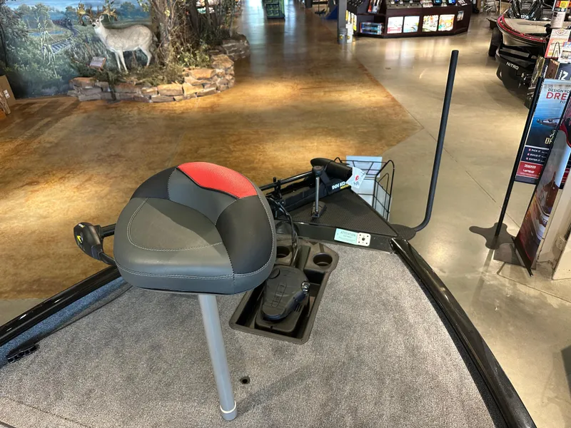 Slide: The Image of 2025 Tracker Savage 215 boat interior with seat and control panel in showroom. - 4