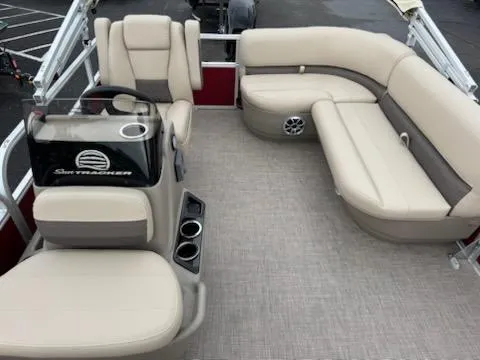 Slide: The Image of 2025 Sun Tracker Bass Buggy 16 XL Select pontoon boat with beige seating and console. - 6