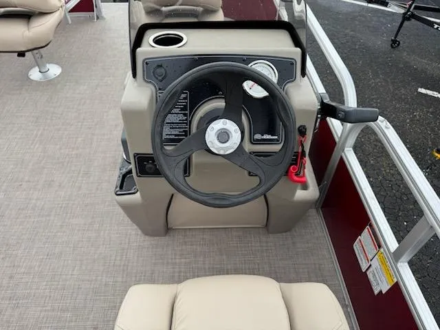 Slide: The Image of 2025 Sun Tracker Bass Buggy 16 XL Select steering console with beige seating and controls. - 8