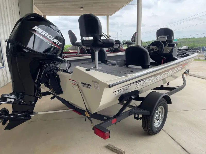 Slide: The Image of 2025 Tracker Pro Team 175 Crappie Edition boat with Mercury engine, parked on trailer. - 4