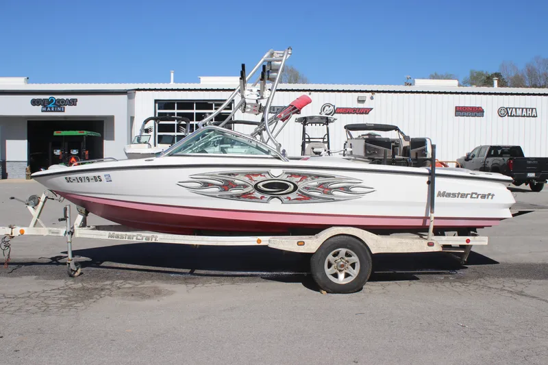 Slide: The Image of 2004 MasterCraft X-9 boat on trailer, parked outside a dealership. - 1