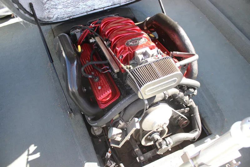 Slide: The Image of 2004 MasterCraft X-9 engine with red components and open compartment view. - 10