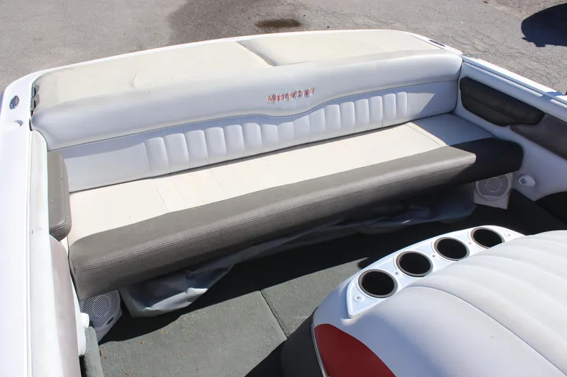 Slide: The Image of 2004 MasterCraft X-9 boat interior with cushioned seating and cup holders. - 4