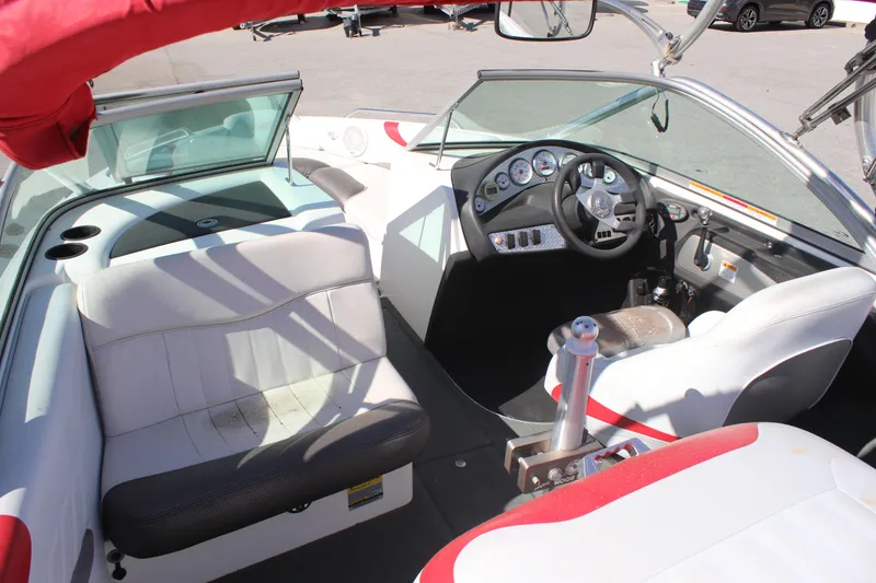 Slide: The Image of 2004 MasterCraft X-9 boat interior with white and red seating, steering wheel, and dashboard controls. - 6