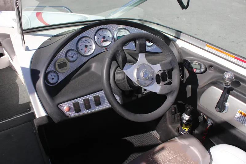 Slide: The Image of 2004 MasterCraft X-9 boat dashboard with steering wheel and gauges. - 7