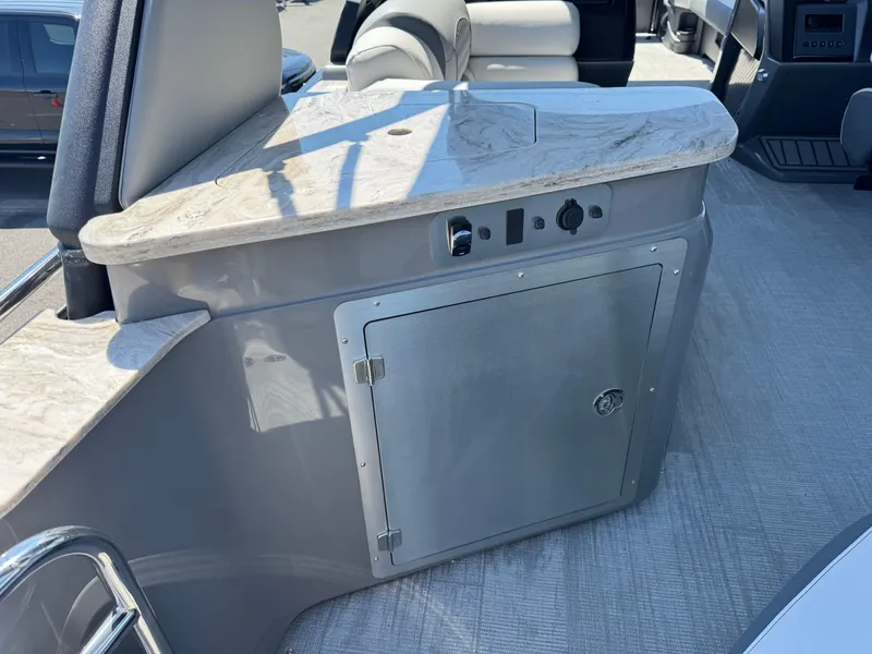 Slide: The Image of Interior of 2025 Avalon Excalibur 27' boat with sleek countertop and storage compartment. - 17