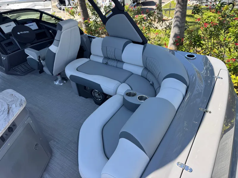 Slide: The Image of Luxurious seating on 2025 Avalon Excalibur 27' boat with modern design and cup holders. - 18