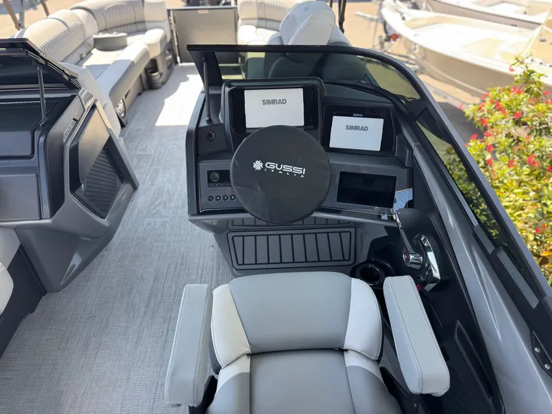 Slide: The Image of 2025 Avalon Excalibur 27' boat interior with modern dashboard and seating. - 23