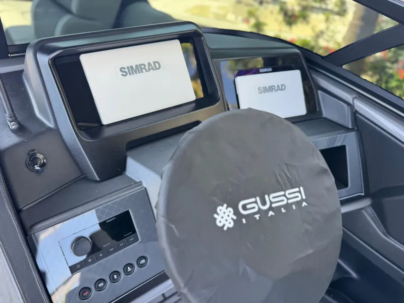 Slide: The Image of 2025 Avalon Excalibur boat dashboard with Simrad displays and Gussi Italia steering wheel. - 24