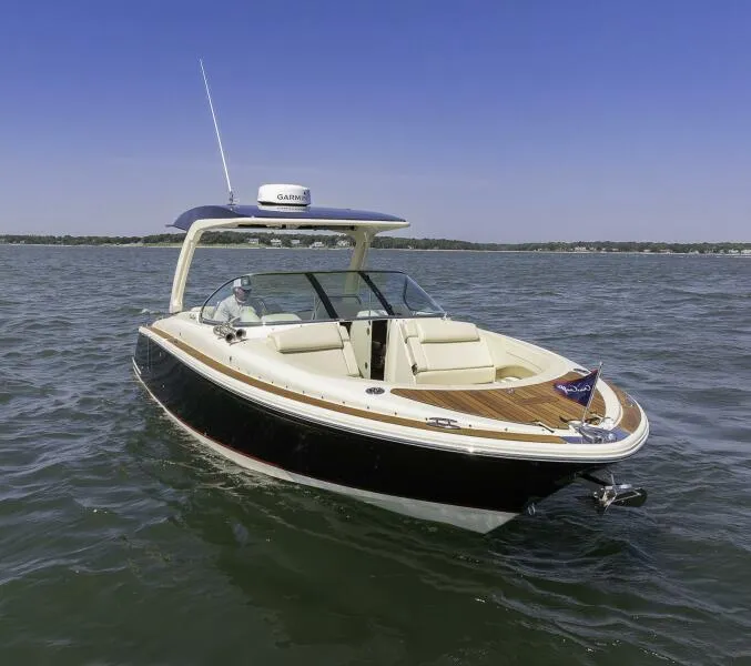 Slide: The Image of 2022 Chris-Craft Launch 31 GT boat cruising on open water. - 0