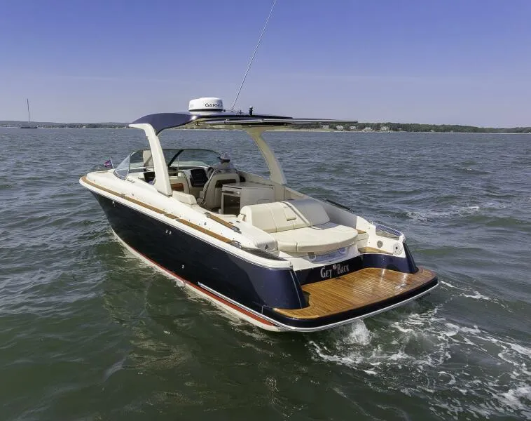 Slide: The Image of 2022 Chris-Craft Launch 31 GT boat cruising on open water. - 2