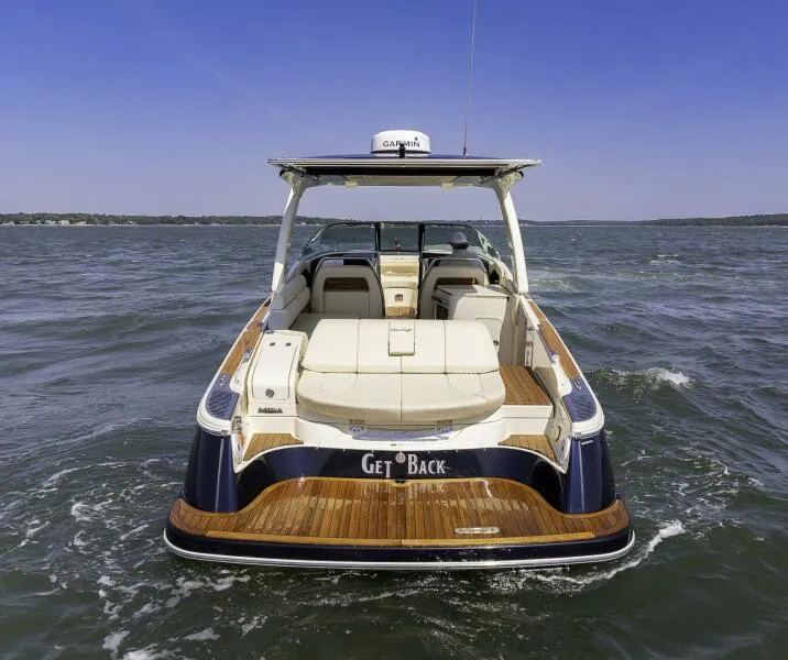 Slide: The Image of 2022 Chris-Craft Launch 31 GT boat on water, rear view, luxury design. - 3