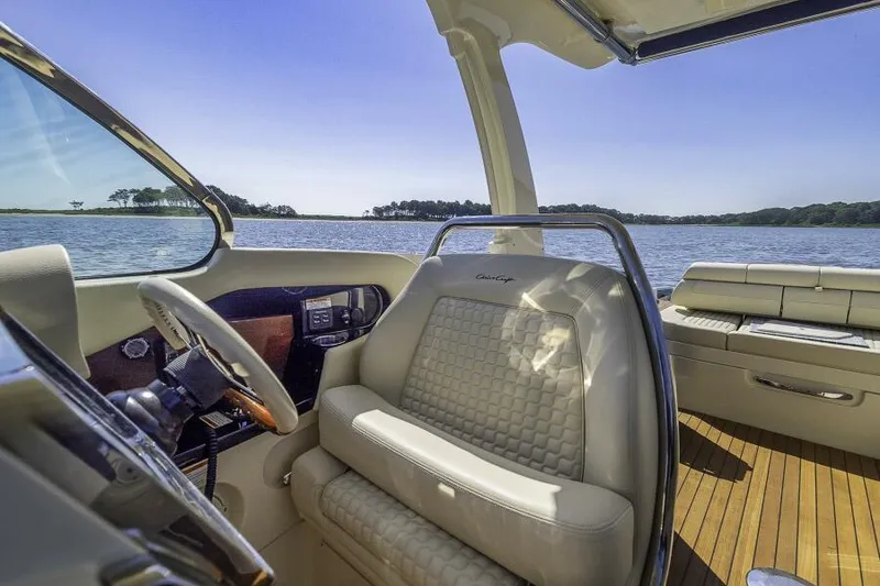 Slide: The Image of 2022 Chris-Craft Launch 31 GT interior with luxurious seating and scenic water view. - 5