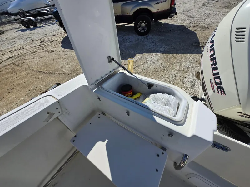 Slide: The Image of 2009 Hydra-Sports Vector 2200 CC boat storage compartment with open lid and visible contents. - 13