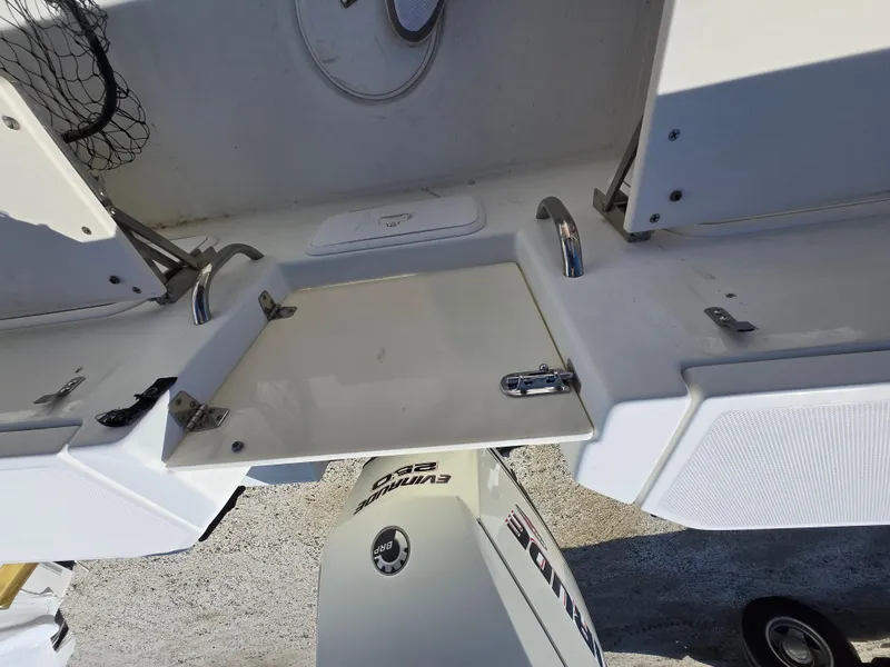 Slide: The Image of 2009 Hydra-Sports Vector 2200 CC boat deck with Evinrude engine, featuring storage compartments. - 15