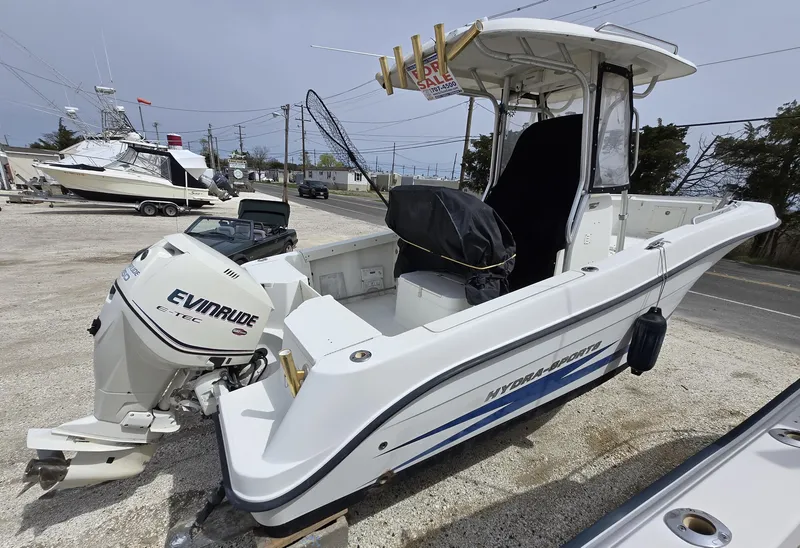 Slide: The Image of 2009 Hydra-Sports Vector 2200 CC boat with Evinrude engine, docked outdoors. - 2