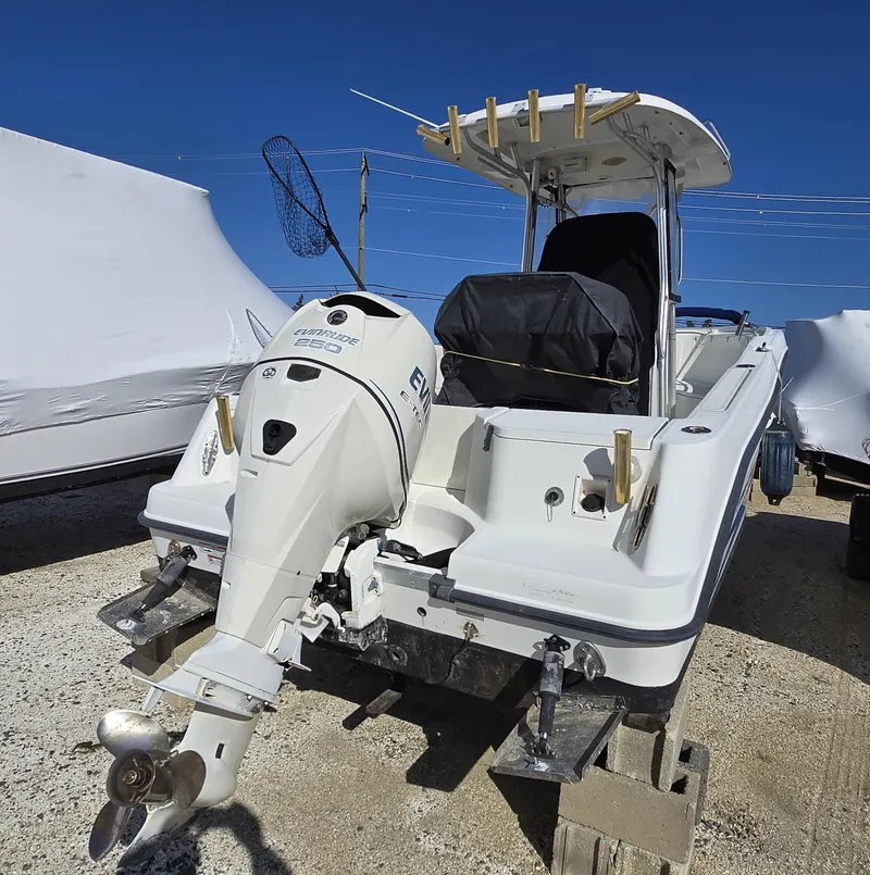 Slide: The Image of 2009 Hydra-Sports Vector 2200 CC boat with outboard motor, docked on land. - 26