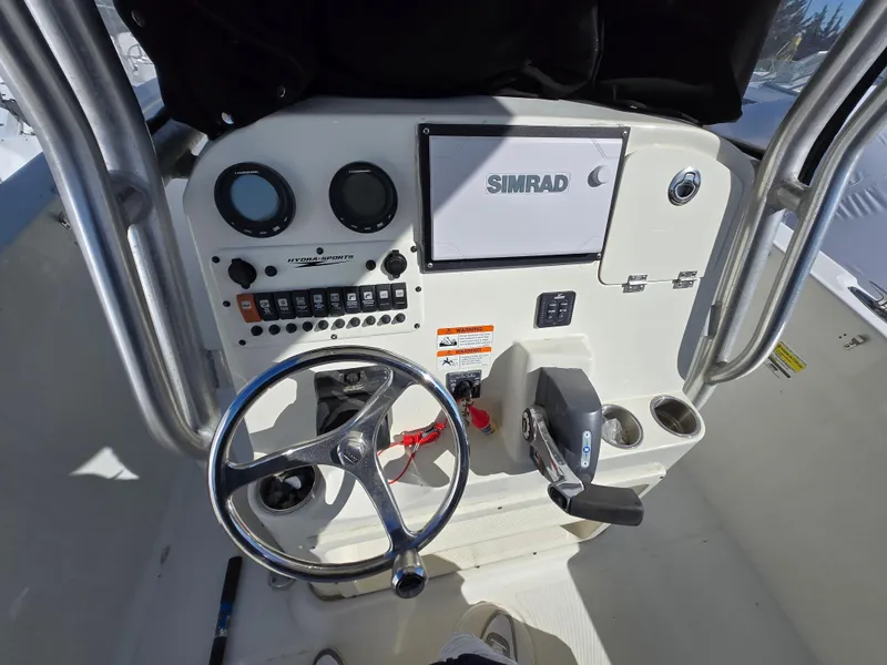 Slide: The Image of 2009 Hydra-Sports Vector 2200 CC boat dashboard with steering wheel and Simrad navigation system. - 3