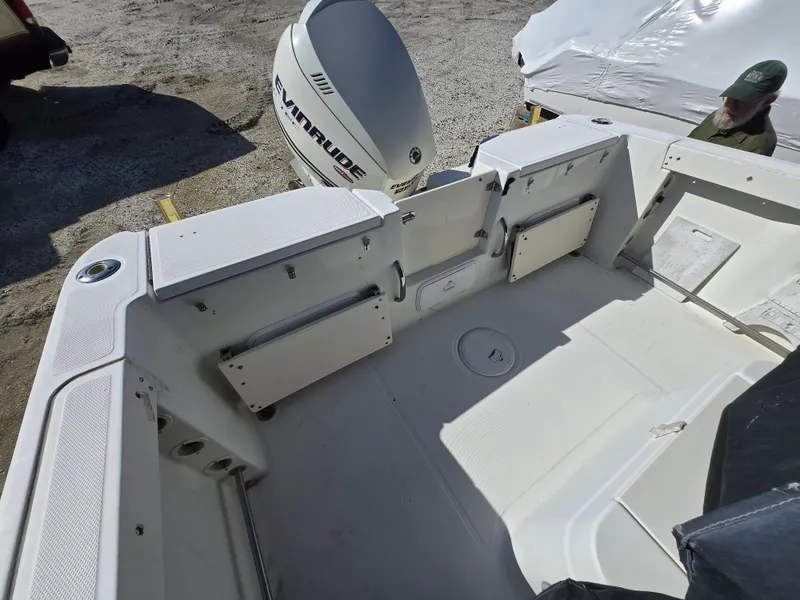 Slide: The Image of 2009 Hydra-Sports Vector 2200 CC boat interior with Evinrude engine, showing spacious deck layout. - 4