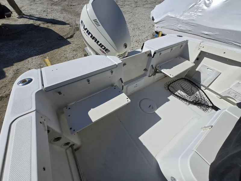 Slide: The Image of 2009 Hydra-Sports Vector 2200 CC boat interior with Evinrude engine, featuring seating and storage. - 8