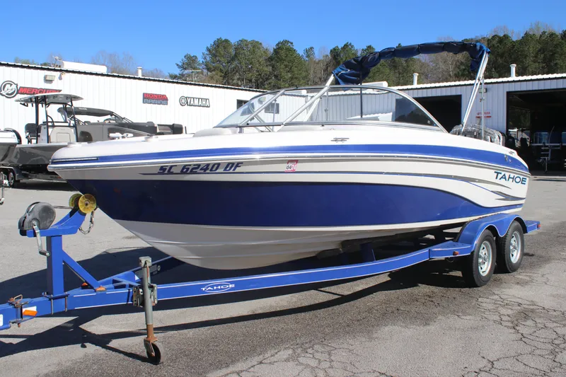 Slide: The Image of 2007 Tahoe Q6 Sport boat on trailer, parked outdoors near a dealership. - 1