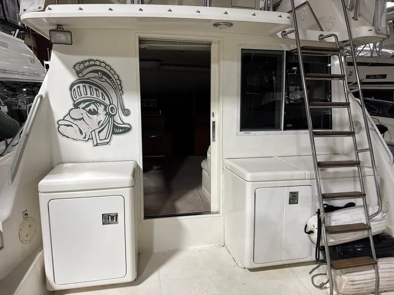 Slide: The Image of 1990 Tiara Yachts 4300 Convertible with ladder and Spartan helmet design on the exterior. - 13