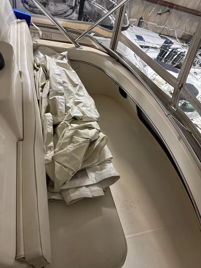 Slide: The Image of 1990 Tiara Yachts 4300 Convertible interior with folded canvas on seating area. - 23