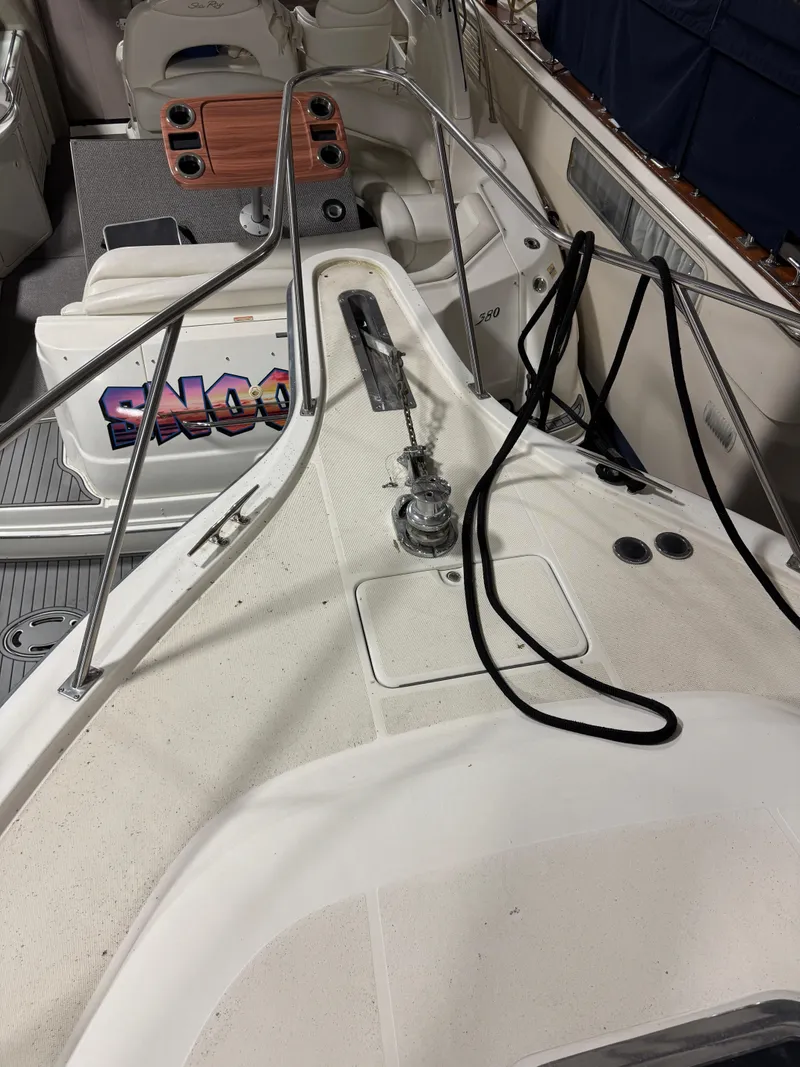 Slide: The Image of 1990 Tiara Yachts 4300 Convertible deck with winch and ropes. - 27