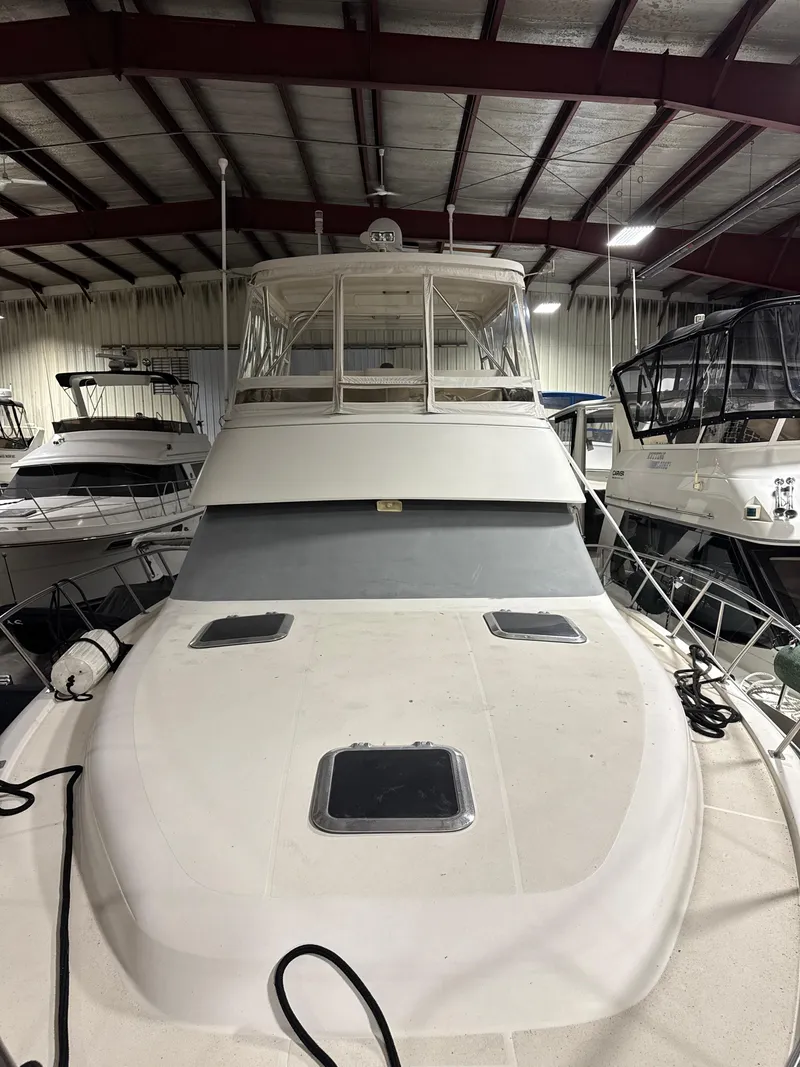 Slide: The Image of 1990 Tiara Yachts 4300 Convertible in indoor storage, front view. - 28