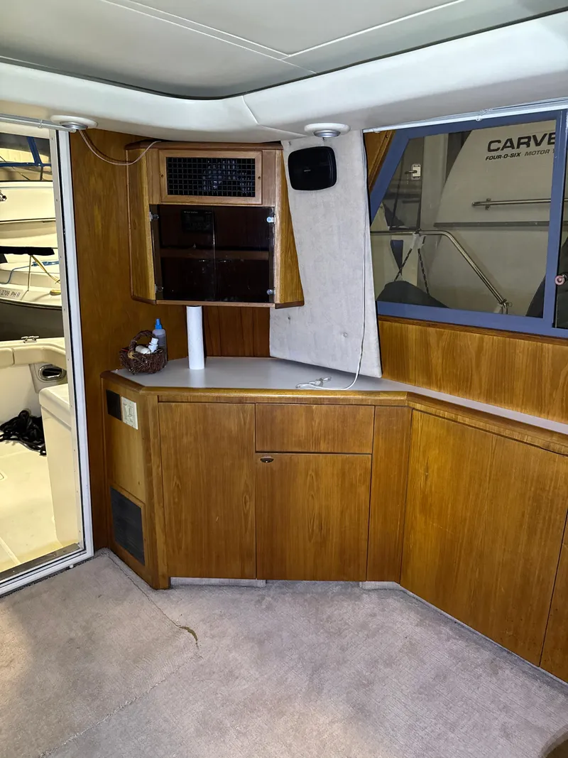 Slide: The Image of 1990 Tiara Yachts 4300 Convertible interior with wood cabinetry and carpeted flooring. - 36