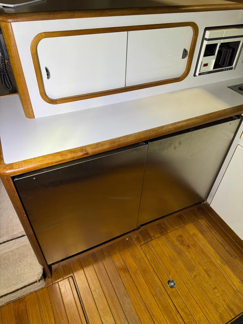 Slide: The Image of 1990 Tiara Yachts 4300 Convertible interior with wood flooring and sleek cabinetry. - 40