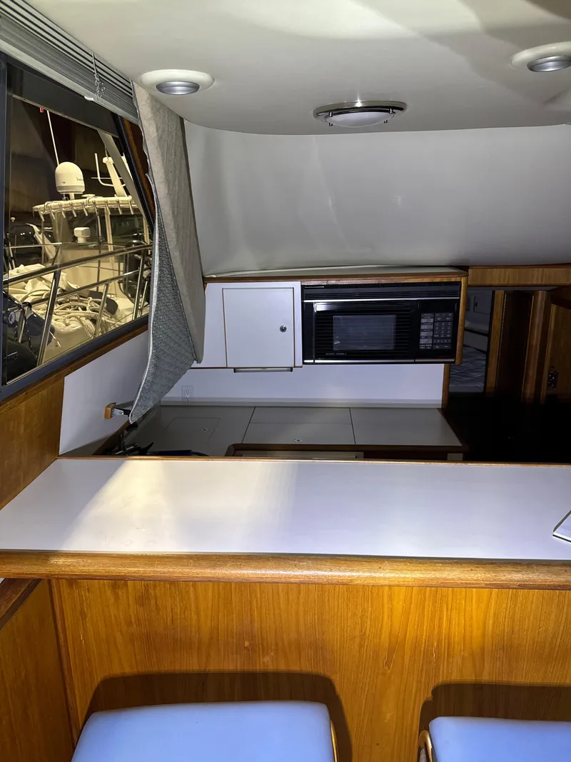 Slide: The Image of Interior of 1990 Tiara Yachts 4300 Convertible with modern kitchen amenities. - 41