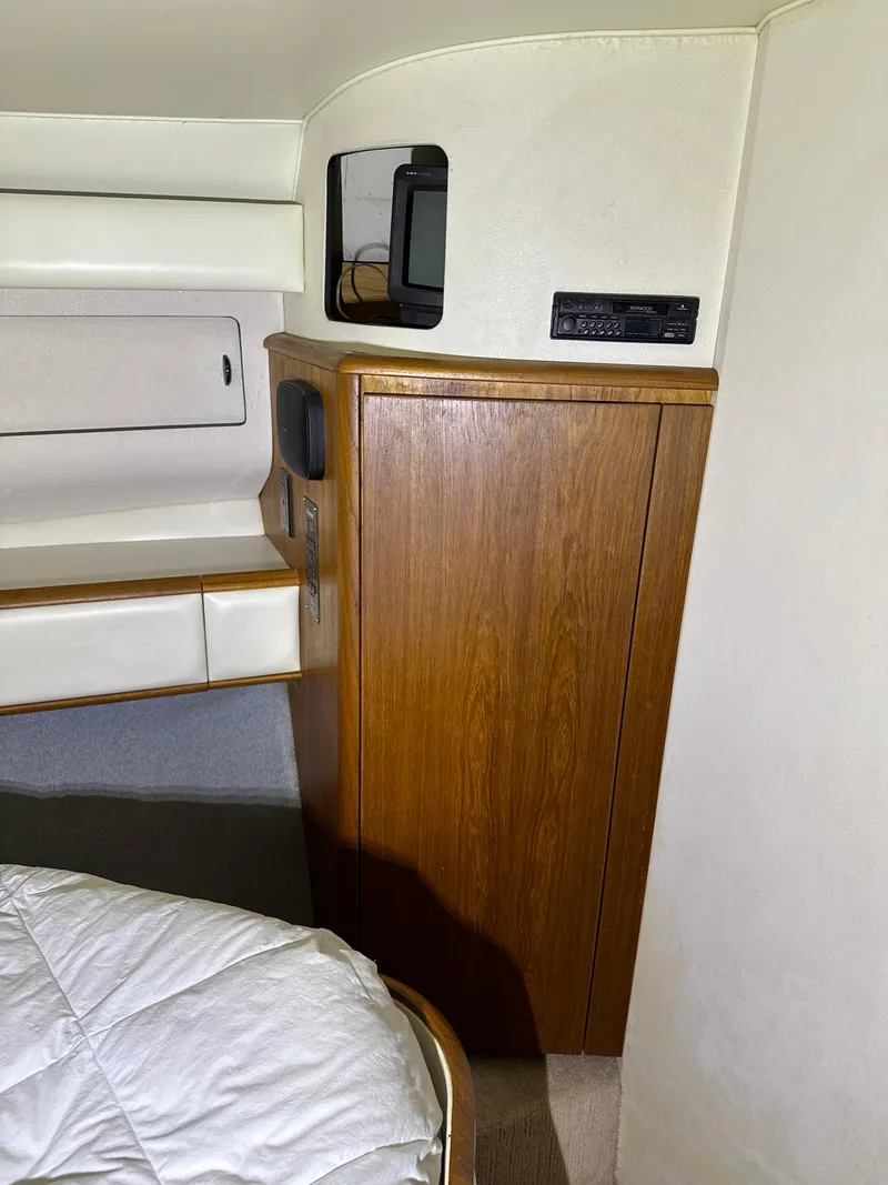 Slide: The Image of 1990 Tiara Yachts 4300 Convertible cabin interior with wood cabinetry and modern amenities. - 44