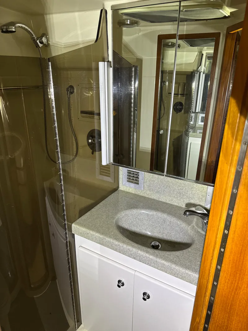 Slide: The Image of Bathroom interior of 1990 Tiara Yachts 4300 Convertible with sink and mirrored cabinet. - 47